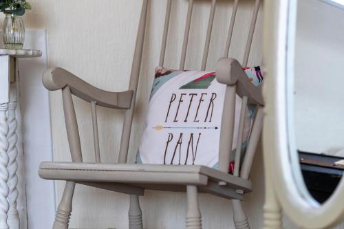 a wooden chair with a book sitting on it at Craigmount in Wigtown