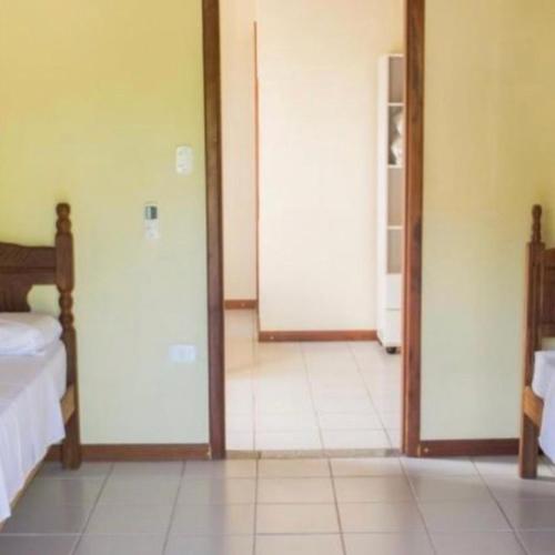 a room with two sliding doors and a bedroom at Suítes NATIVA in Paraty