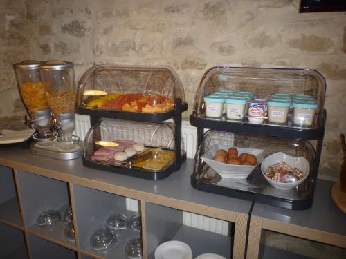 two trays of food on top of a table at Logis Hôtel La Bastide Saint Bach in Suze-la-Rousse