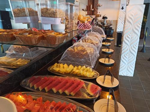 a buffet with many different types of food on display at Pousada Villa Goyá in São José da Coroa Grande