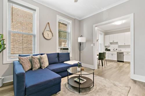 a living room with a blue couch and a table at 2BR Comfy and Stylish Apt in West Town - Erie 1R in Chicago