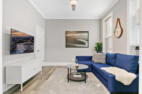 a living room with a blue couch and a table at 2BR Comfy and Stylish Apt in West Town - Erie 1R in Chicago