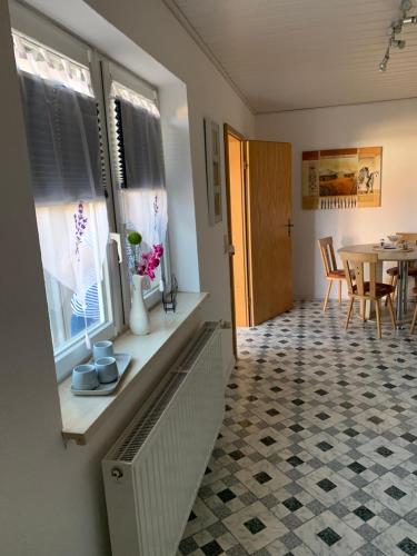 a living room with a table and a window at Ferienwohnung Römmer in Ströbeck