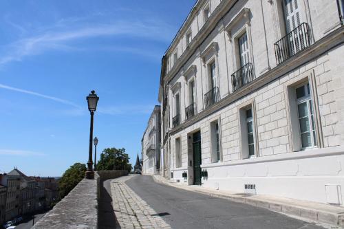 an empty street next to a building with a light pole at Le Rempart du Midi in Angoulême