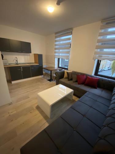 a living room with a couch and a coffee table at Kispet Deluxe Hotels&Suites in Oberhausen