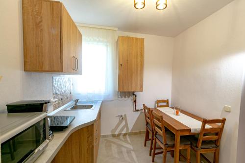 a kitchen with a table and a dining room at Rosenthal House in Sighişoara