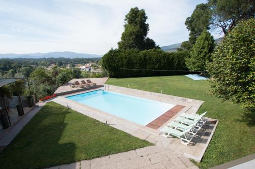a swimming pool with lounge chairs in a yard at Quinta da Devesa in Valença