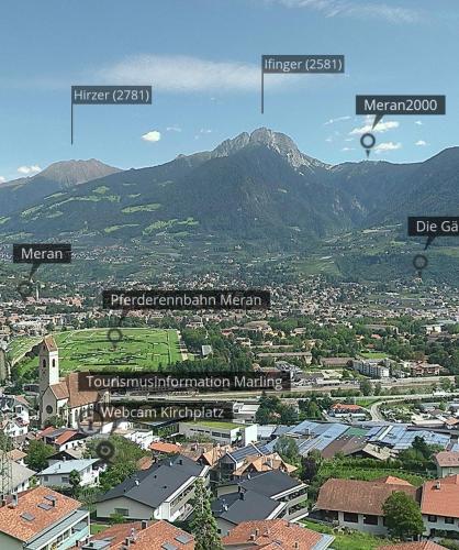 a view of a city with mountains in the background at Marlingsuites - Vinea - Wieser Josef - Marling in Marlengo