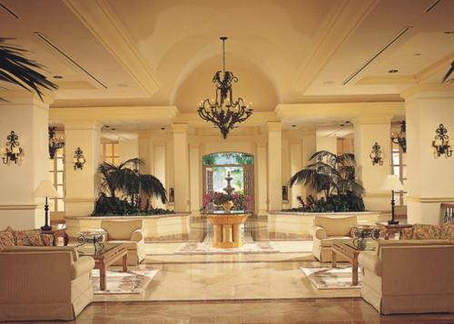 a lobby with a fountain in the middle of a building at Grand Isla Navidad Golf & Spa Resort with Marina in Barra de Navidad