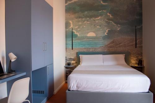 a bedroom with a bed with a painting on the wall at Relais Villa Montedonzelli in Naples