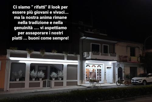 a building with a sign on the side of it at night at Albergo B&B Ristorante Grace in Vibo Valentia