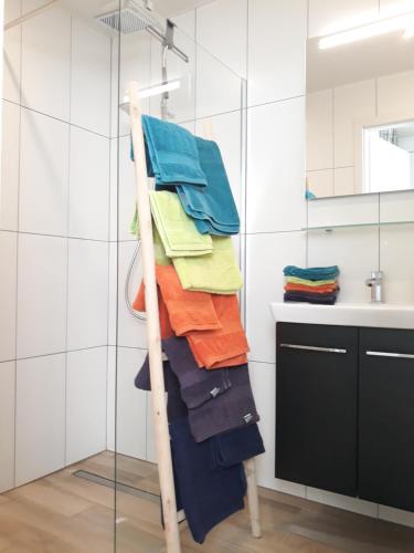 a towel rack in a bathroom with colorful towels at Chalet l'Orvallée in Virton
