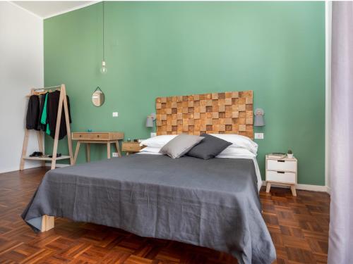 a bedroom with a large bed with blue walls at Nartè Rooms in Naples