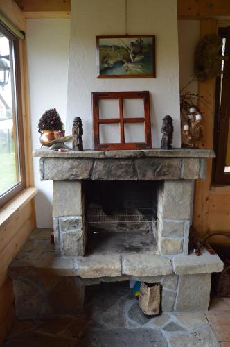 a stone fireplace in the corner of a room at amel orawa in Podwilk
