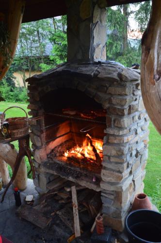 a stone oven with a fire inside of it at amel orawa in Podwilk