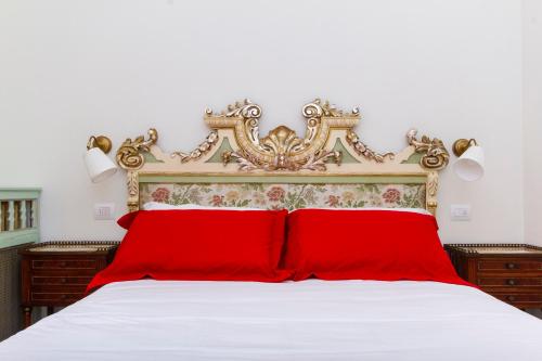a bedroom with a red bed with a white bedspread at Casa della Contessa B&B in Turin