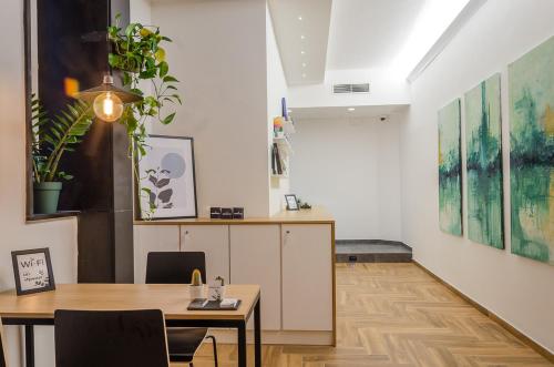 a dining room with a table and chairs and paintings at URBANFLORA in Genova