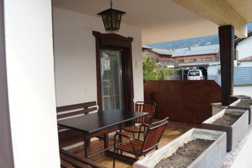 a patio with a table and chairs on a porch at FEWO Außerlechner in Innsbruck