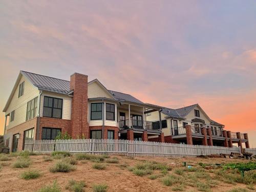 een huis aan het strand met een hek bij Annie's Place Bed & Breakfast in Boulder Town