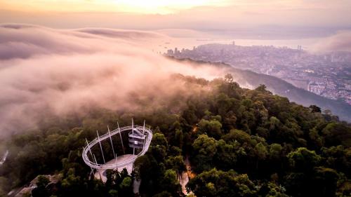 an aerial view of a mountain with fog in the forest at Kingston Hotel 13 - Penang Hills formerly known as Deview Hotel in Ayer Itam
