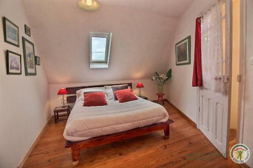 a bedroom with a large bed with a wooden floor at Gîtes Air Marin in Becléguer