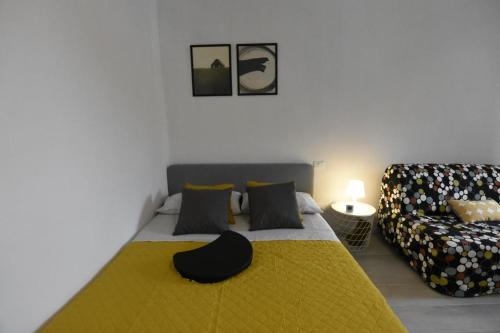 a bedroom with a bed and a couch at La Casa di Oreno in Vimercate