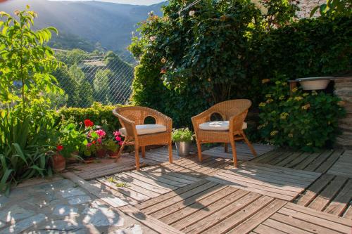 two chairs sitting on a deck with a view at Casa-Huerto La Juana in Trevélez