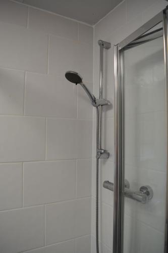 a shower with a glass door in a bathroom at Riverside House in Hamble
