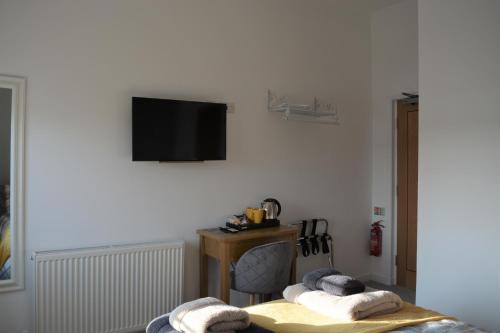 a living room with a tv on a white wall at Riverside House in Hamble