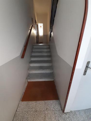 a stairway leading up to a room with a stair case at La Duchessa in Alba