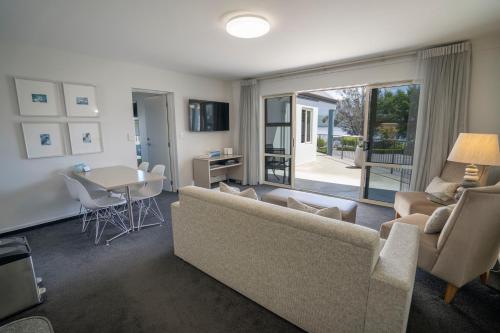 a living room with a couch and a table at Radfords on the Lake in Te Anau