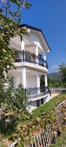 a white building with balconies on the side of it at Villa Bratislava in Demir Kapija