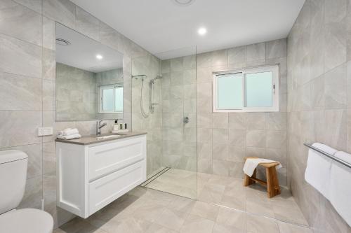 a bathroom with a shower and a toilet and a sink at Zephyr on Sapphire in Sapphire Beach