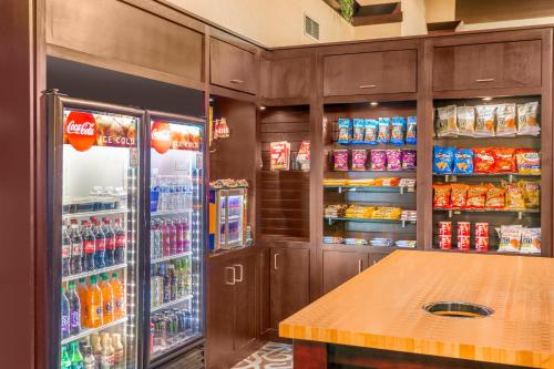a kitchen with a refrigerator and some drinks in it at Hotel Gurnee in Gurnee