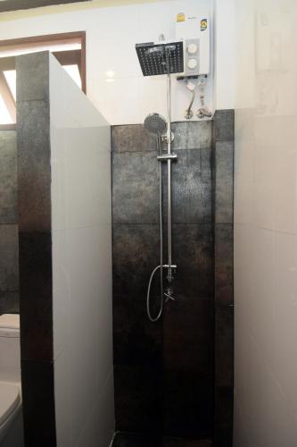a shower stall in a bathroom with a sink at Clean Beach Resort in Ko Lanta