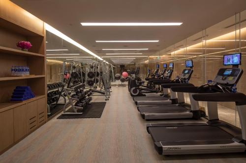 a gym with a row of treadmills and machines at Crowne Plaza Fuzhou South by IHG in Fuzhou