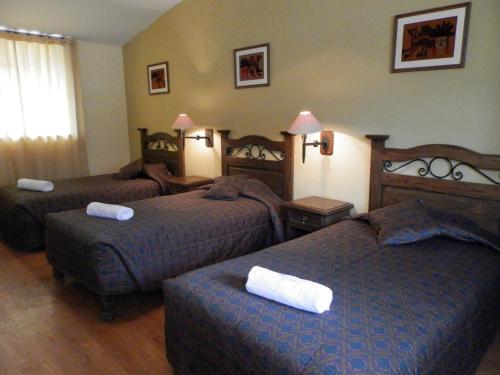 a hotel room with two beds in a room at La Posada del Conde Lodge in Cabanaconde