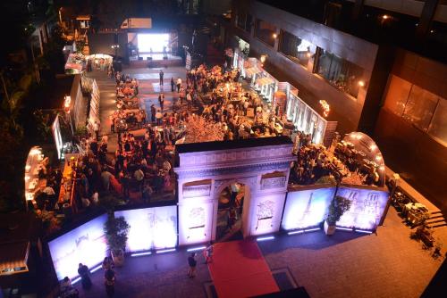 an overhead view of a crowd of people in a building at night at Sofitel Mumbai BKC in Mumbai