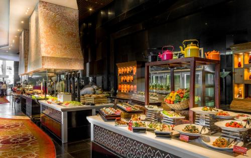 a buffet line with many different types of food at Sofitel Mumbai BKC in Mumbai