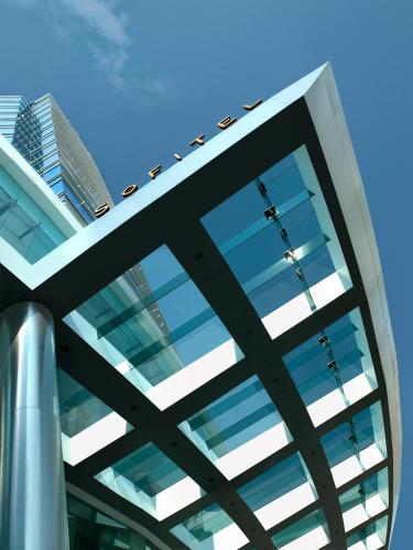 a view of a glass building with tall buildings in the background at Sofitel Mumbai BKC in Mumbai