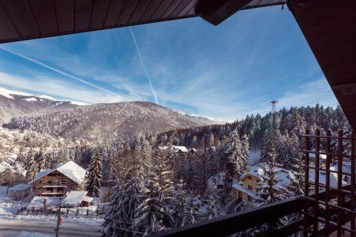 a view from a balcony of a ski resort in the snow at Hotel Regal in Sinaia