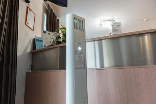 
a kitchen with a refrigerator and a counter top at Apart Hotel Tomo FREE PARKING in Rīga
