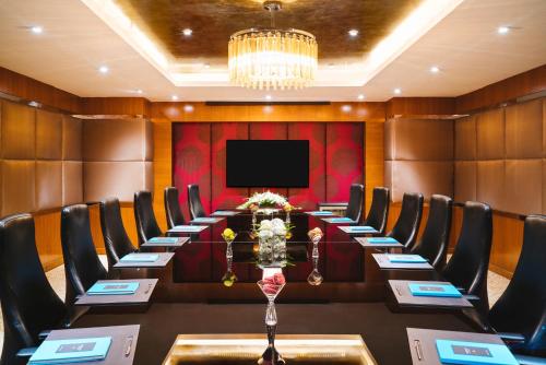 a conference room with a long table and chairs at Sofitel Mumbai BKC in Mumbai