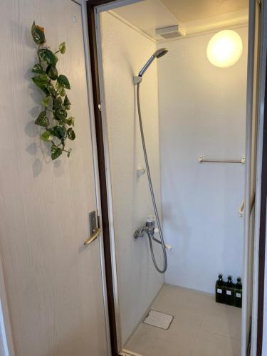 a shower stall in a bathroom with a shower at Takemura Building 303 in Tokyo