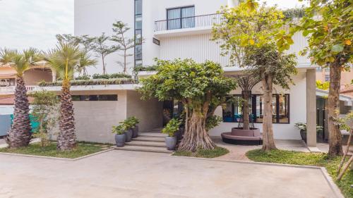 a house with palm trees in front of it at Angkor Aurora in Siem Reap