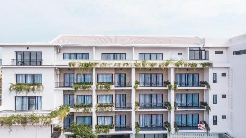 an apartment building with windows and plants at Angkor Aurora in Siem Reap