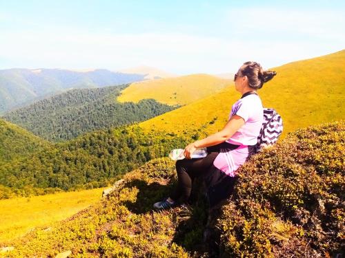 a woman sitting on the top of a mountain at Family Green in Sasovka