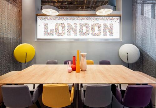 a conference room with a wooden table and chairs at YOTEL London City in London
