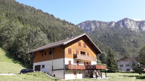 a wooden house with a balcony on a mountain at Grand Bornand-La Clusaz in Entremont