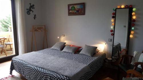 a bedroom with a bed with a black and white blanket at Margouillat chambre d'hôte in Figeac